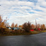 picture of real estate commercial land on olive road in Anchorage Alaska. Corner picture with blue equipment in background.