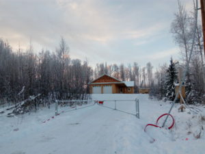Outdoor in winter with gate on hillside house, commercial real estate in Alaska